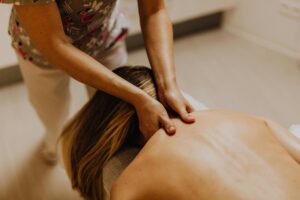 a person receiving a shoulder and upper back massage